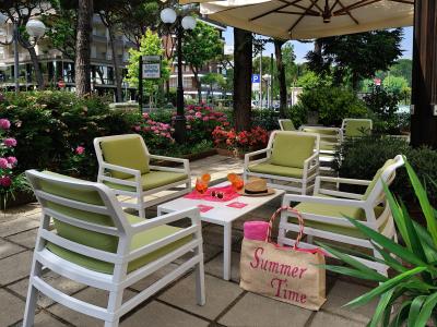 Relax area with green chairs, table, and 'Summer Time' bag.