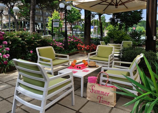 Relax area with green chairs, table, and 'Summer Time' bag.